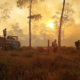 Volunteers and firefighters combat the fires that went out of control during the burning of forests and pastures for agricultural purposes around the touristic small town of Rurrunabaque, Beni Department, Bolivia, on October 26, 2023. The dense smoke that affects Bolivia's main cities is due to the burning of forests and pastures, a common practice that usually starts in the middle of the year. The aim is to expand the agricultural frontier, even though the government says it is prohibited by law. (Photo by CRISTIAN CASTRO / AFP)